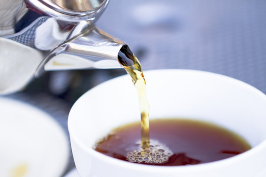 Pouring Hot Tea From Restaurant Style Cattle