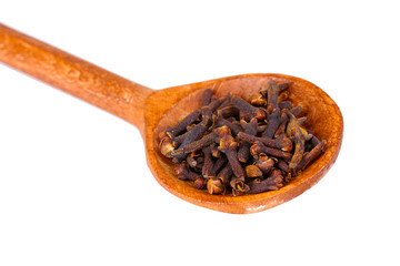 spices in the spoons isolated on white