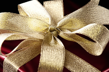 Close-up of golden gift bow, studio shot