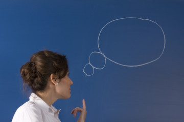 Image of young woman thinking on green board