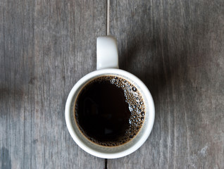 Top view cup of coffee on wood background