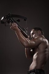 Fototapeta na wymiar portrait of athletic young man with crossbow