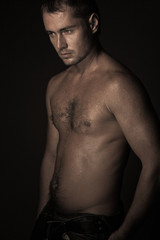 Fototapeta premium athletic young man with dewdrops on body