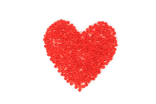 Heart made ??of red beads, isolated on red background.