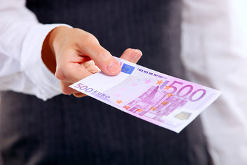 Female hand holding five hundred euro banknote