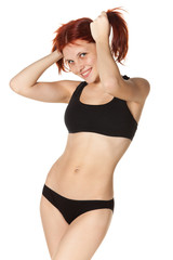 Cheerful girl in black sports lingerie.