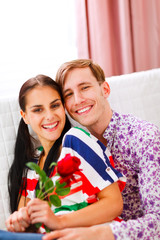 Cheerful couple in love enjoying themselves at home