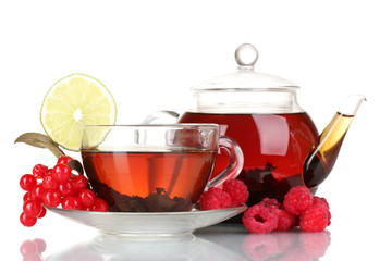 Black fruit tea in glass teapot and cup isolated on white