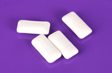 Chewing gums on purple background
