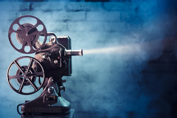 old film projector with dramatic lighting - obrazy, fototapety, plakaty