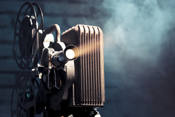 old film projector with dramatic lighting - obrazy, fototapety, plakaty