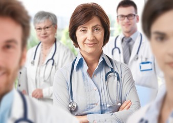 Fototapeta premium Female doctor with medical team