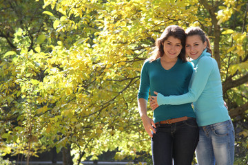 two young happy women on natural background