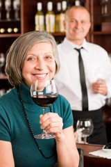 Wine bar senior woman enjoy wine glass
