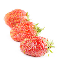 Three strawberries on a white background