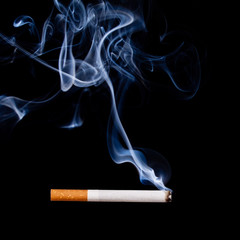 Smoking cigarette. Isolated on black.