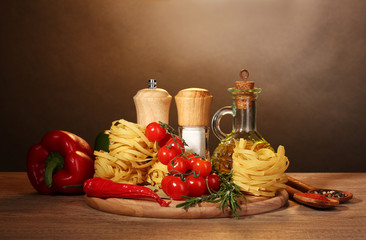 noodles in bowl, jar of oil, spices and vegetables