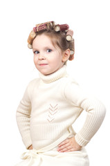 Beautiful little girl with curlers on her head.