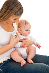 Fototapeta na wymiar Mother giving vitamins to infant girl isolated on white