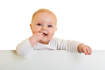 Isolated beaufiful caucasian infant baby behind whiteboard