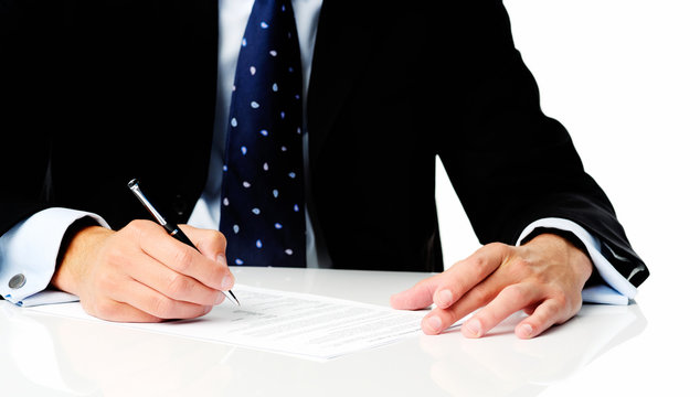 Anonymous man in suit signing a contract