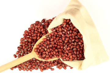 Organic Azuki Beans in Fabric bag and wooden spoon.