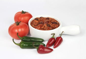 bowl of chili with tomatos and peppers