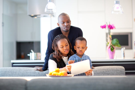 Young Black Family In Fresh Modern Kitchen