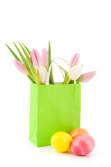 Easter eggs and tulips in paper bag