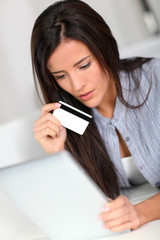 Fototapeta premium Young woman doing online shopping with tablet