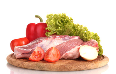 Raw meat and vegetables on a wooden board isolated on whitе