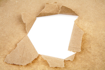 Hole ripped in brown paper