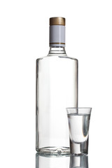 Bottle of vodka and wineglass isolated on white