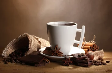 Zelfklevend Fotobehang cup of hot chocolate, cinnamon sticks, nuts and chocolate © Africa Studio