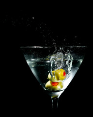 Two Olives Splashing into Martini Glass