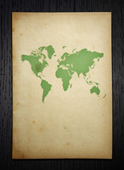 vintage world map on dark wood  background with clipping path