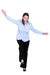 Woman pretending to walk on tight-rope