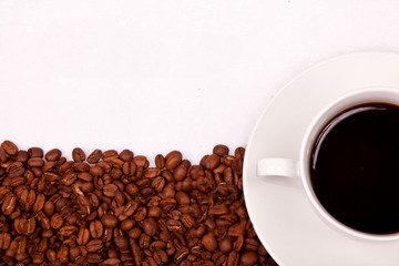 Coffee in a cup with lots of coffee beans