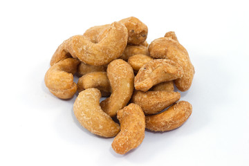 Heap of a roasted cashew nuts. Isolated on white background.