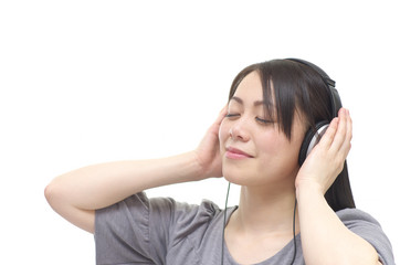 Naklejka premium Asian woman listening music