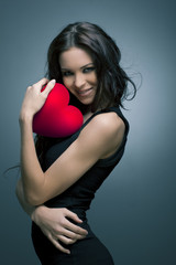 Valentine's Day. Beautiful smiling woman with a gift