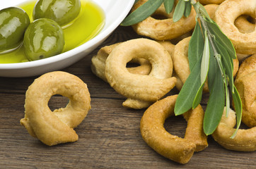 Taralli biscuit with ingredients on the wood table