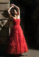 Dramatic portrait of the beautiful woman in red dress