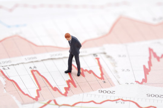 Financial crisis. Figure of businessman on financial charts