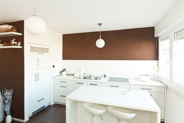 Modern kitchen with brown wall above the counter