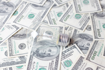 light bulb on dollar bills