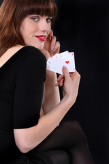 Woman holding four aces