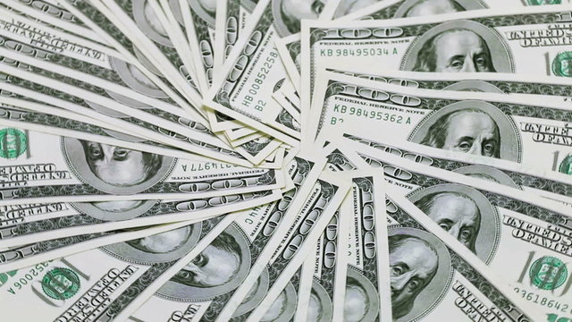 Rotating 100 US dollars bank notes business background