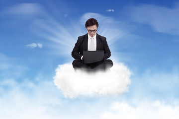 Asian Businessman Working on top of a cloud