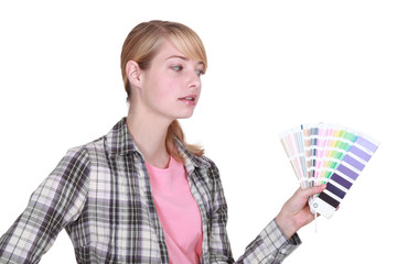 female painter holding a color chart